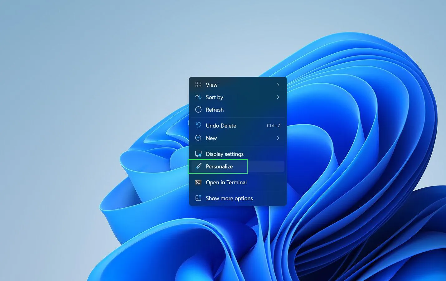 Right-click anywhere on an empty space of the desktop then Select ‘Personalize’ from the context menu that appears